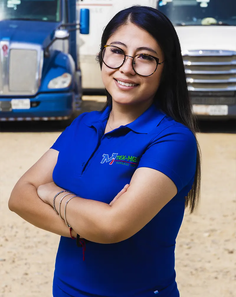 Image of a Tex-Mex employee in front of Tex-Mex trucks. smiling with pride and crossed arms.